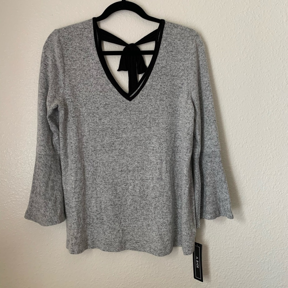 light gray sweater with bell shaped sleeves